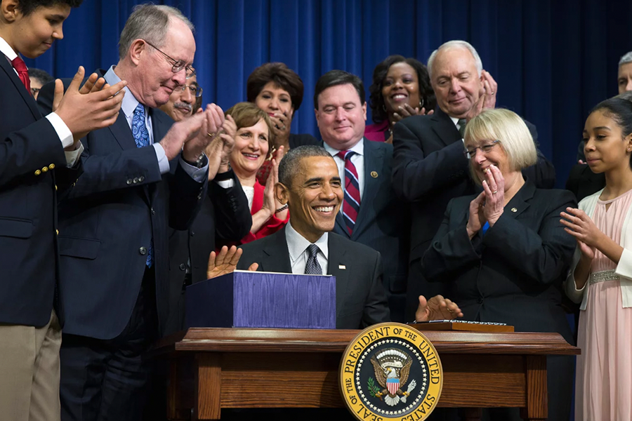 President Obama signs bipartisan act for students amidst crowd
