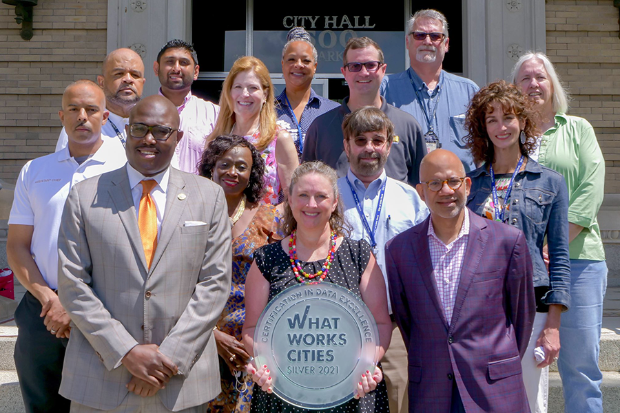 City of Little Rock officials pose in front of their What Works City Certification plaque